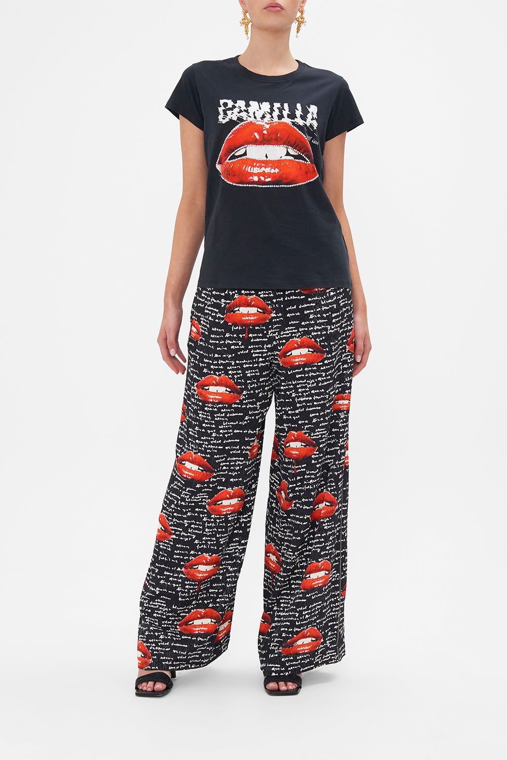 Front untucked view of model wearing CAMILLA black graphic tee in Chaos Magic print 