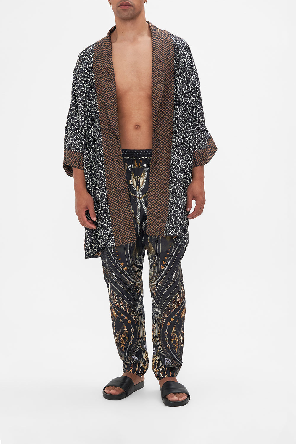 Full length view of model wearing Hotel Franks by CAMILLA mens silk robe in Chaos In The Cosmos  animal print 