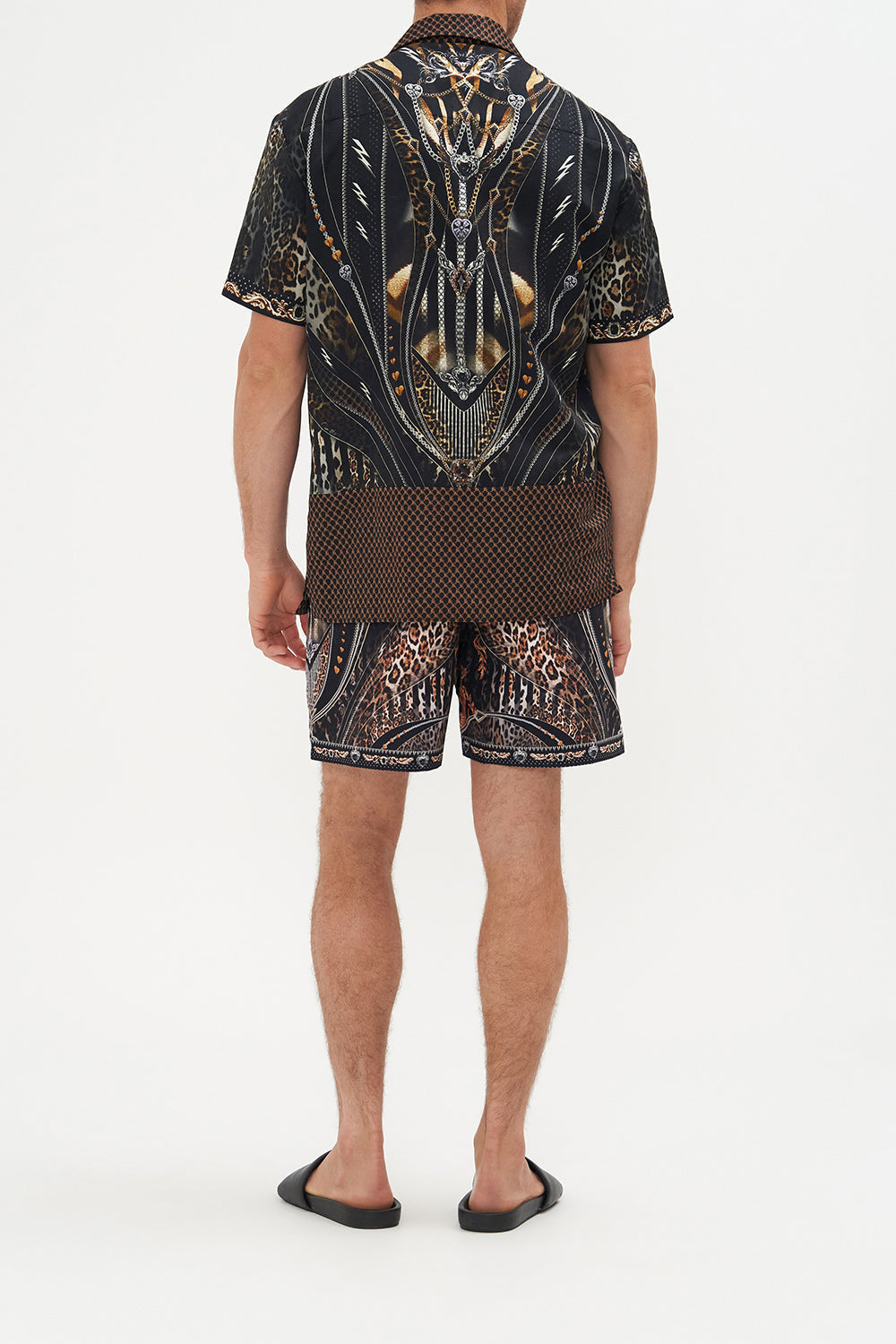 Back view of model wearing Hotel Franks by CAMILLA mens elastic waist boardshorts in Chaos In The Cosmos animal print 