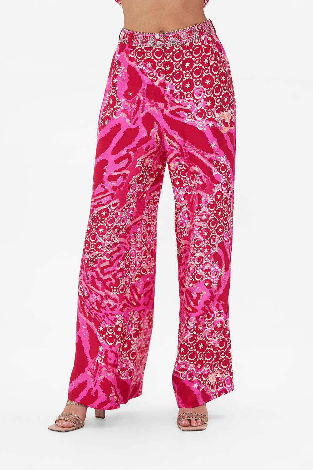 Crop view of model wearing CAMILLA silk palazzo pants in Song Of Sacrifice print