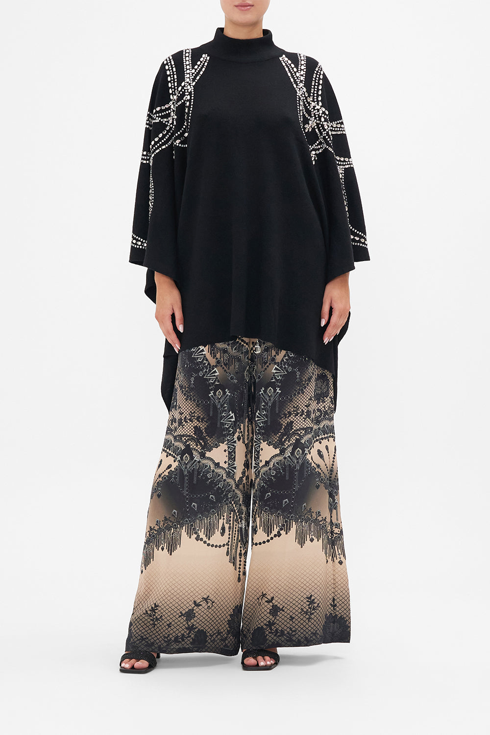 Front view of model wearing CAMILLA knit poncho in Curtain Call Chaos print