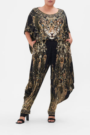 Front view of curvy model wearing CAMILLA plus size animal print jersey drape pant in Lions Mane print