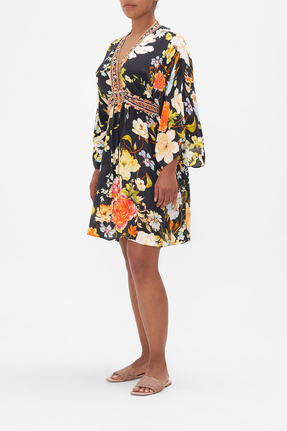 Side view of model wearing CAMILLA floral silk kaftan in Secret History print