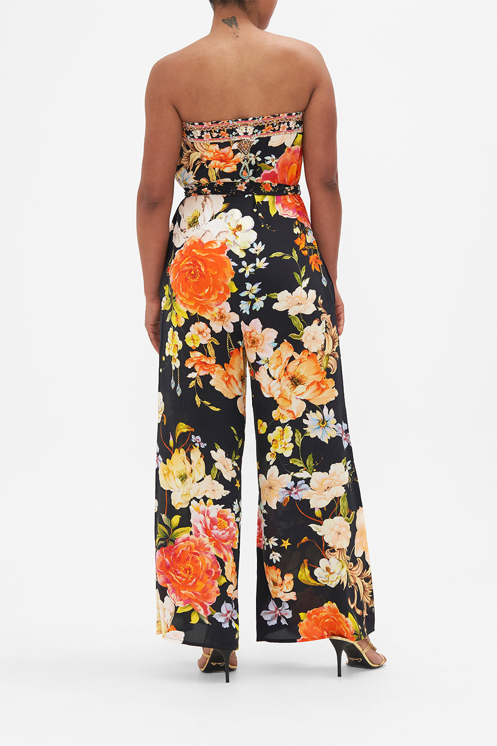 Back view of model wearing CAMILLA strapless floral silk jumpsuit in Secret History print