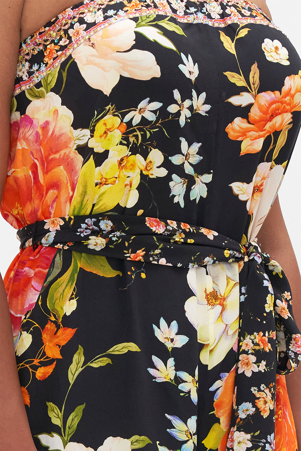 Detail view of model wearing CAMILLA strapless floral silk jumpsuit in Secret History print