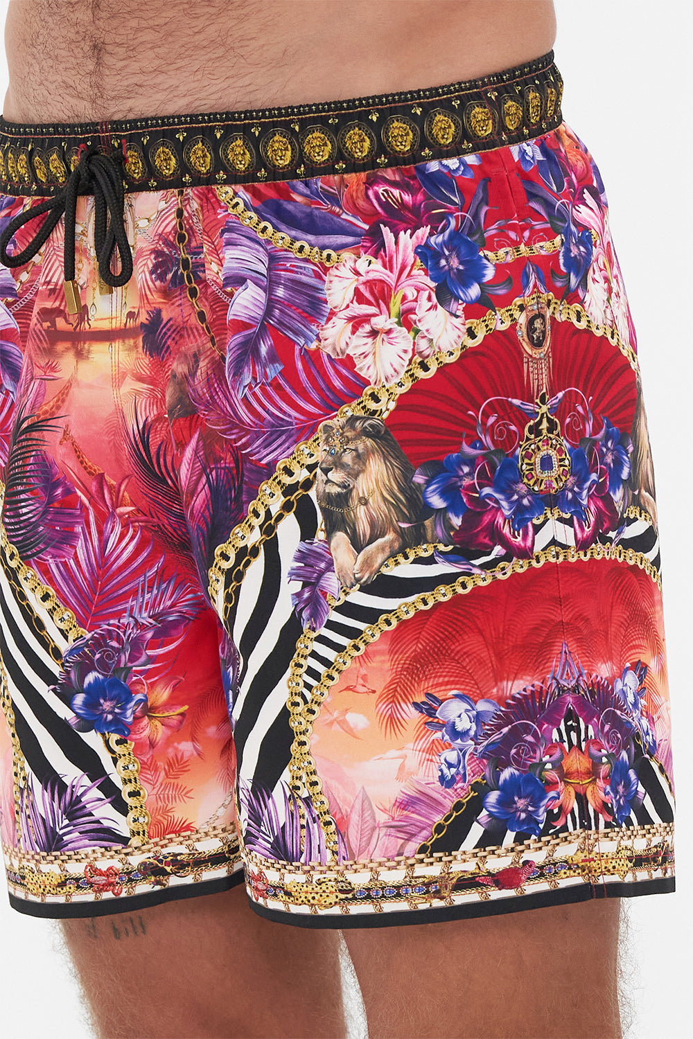Detail view of model wearing Hotel Franks by CAMILLA mens tropical print boardshorts in Wild Loving print