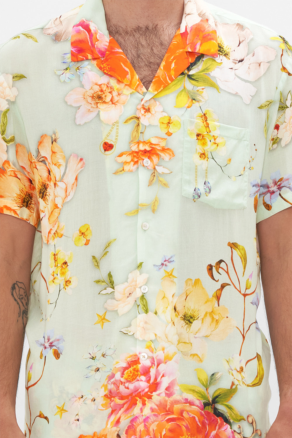 Detail view of model wearing Hotel Franks by CAMILLA mens floral short sleeved camp collared shirt in Talk The Walk print