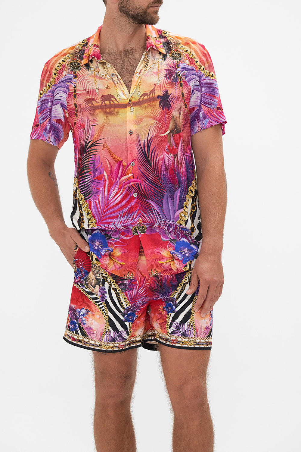 Crop view of model wearing Hotel Franks by CAMILLA mens tropical short sleeve button through shirt in Wild Loving print