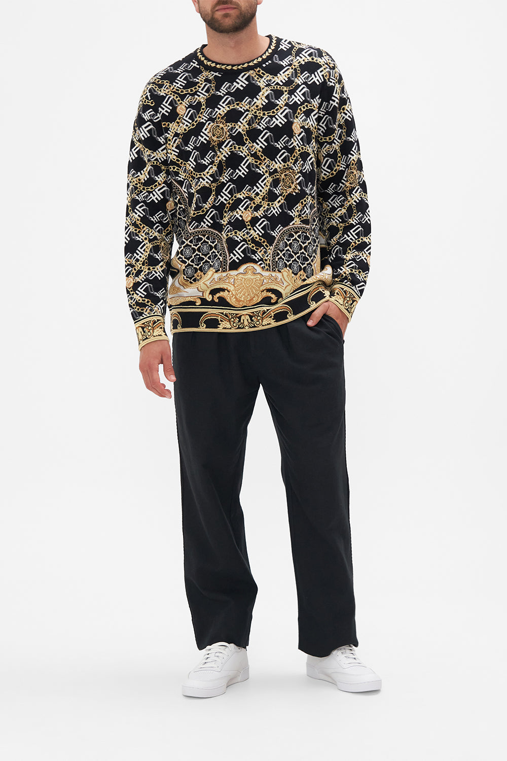 Front view of model wearing Hotel Franks by CAMILLA mens oversized knit sweater in black and gold Tether Me Not print