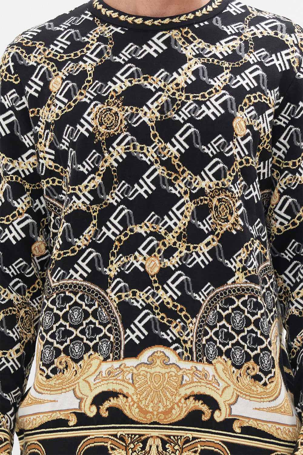 Detail view of model wearing Hotel Franks by CAMILLA mens oversized  knit sweater in black and gold Tether Me Not print