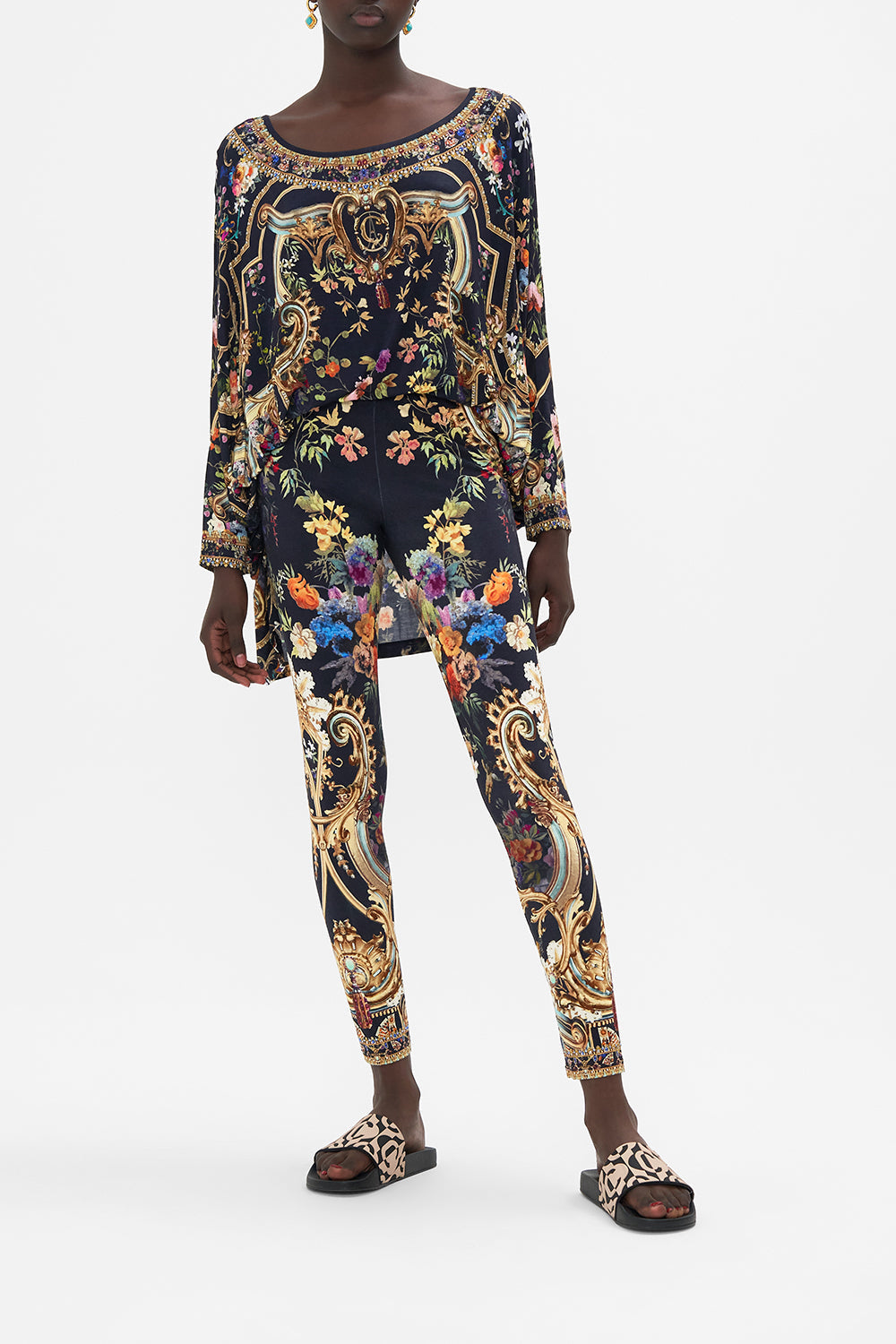 Front view of model wearing CAMILLA floral print leggings in Play Your Cards Right print