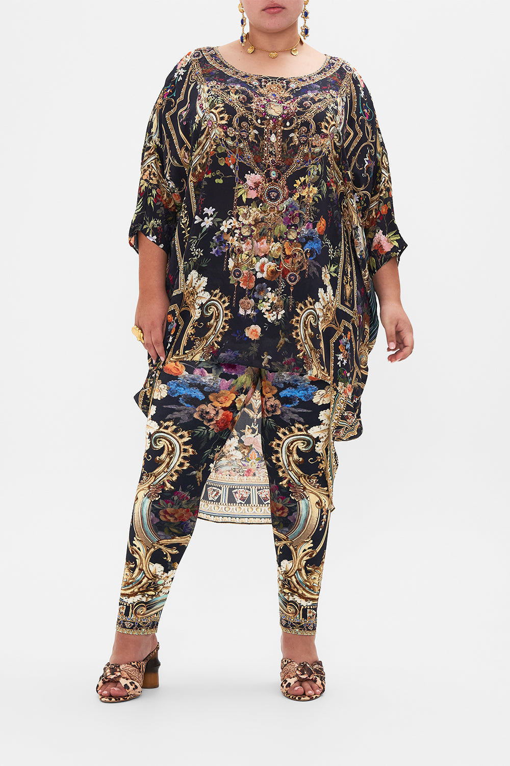 Front view of curvy model  wearing CAMILLA plus size floral leggings in Play Your Cards Right print