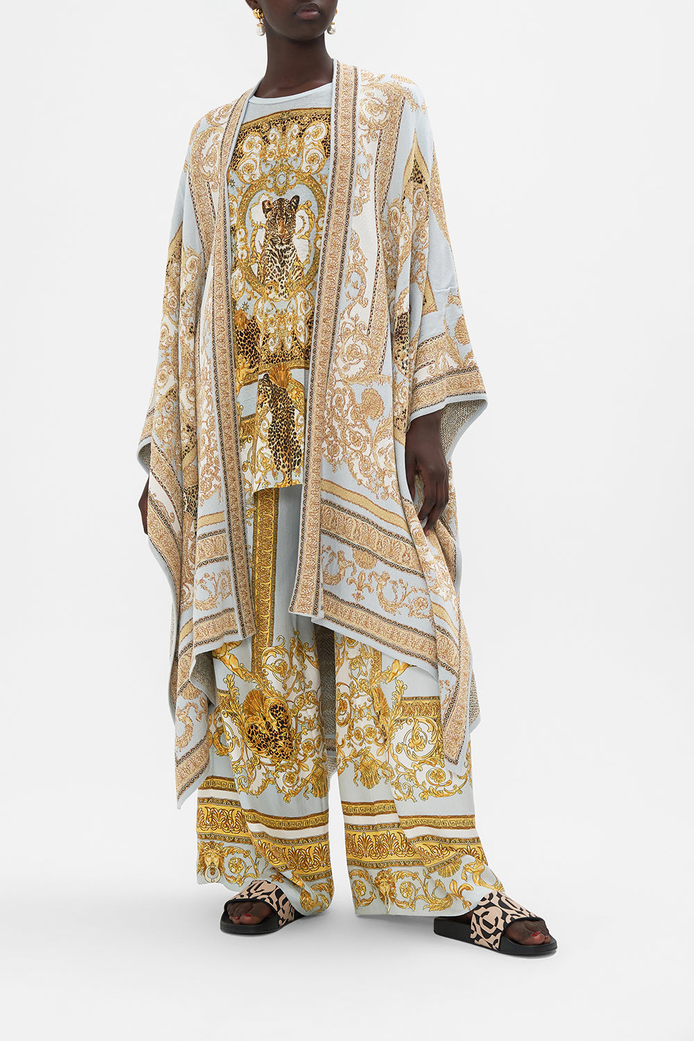 Front view of model wearing CAMILLA throw over knit in Palazzo Pride print