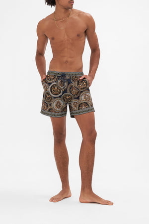 Front view of model wearing HOTEL FRANKS BY CAMILLA mens boardshorts in Duomo Kaleido print