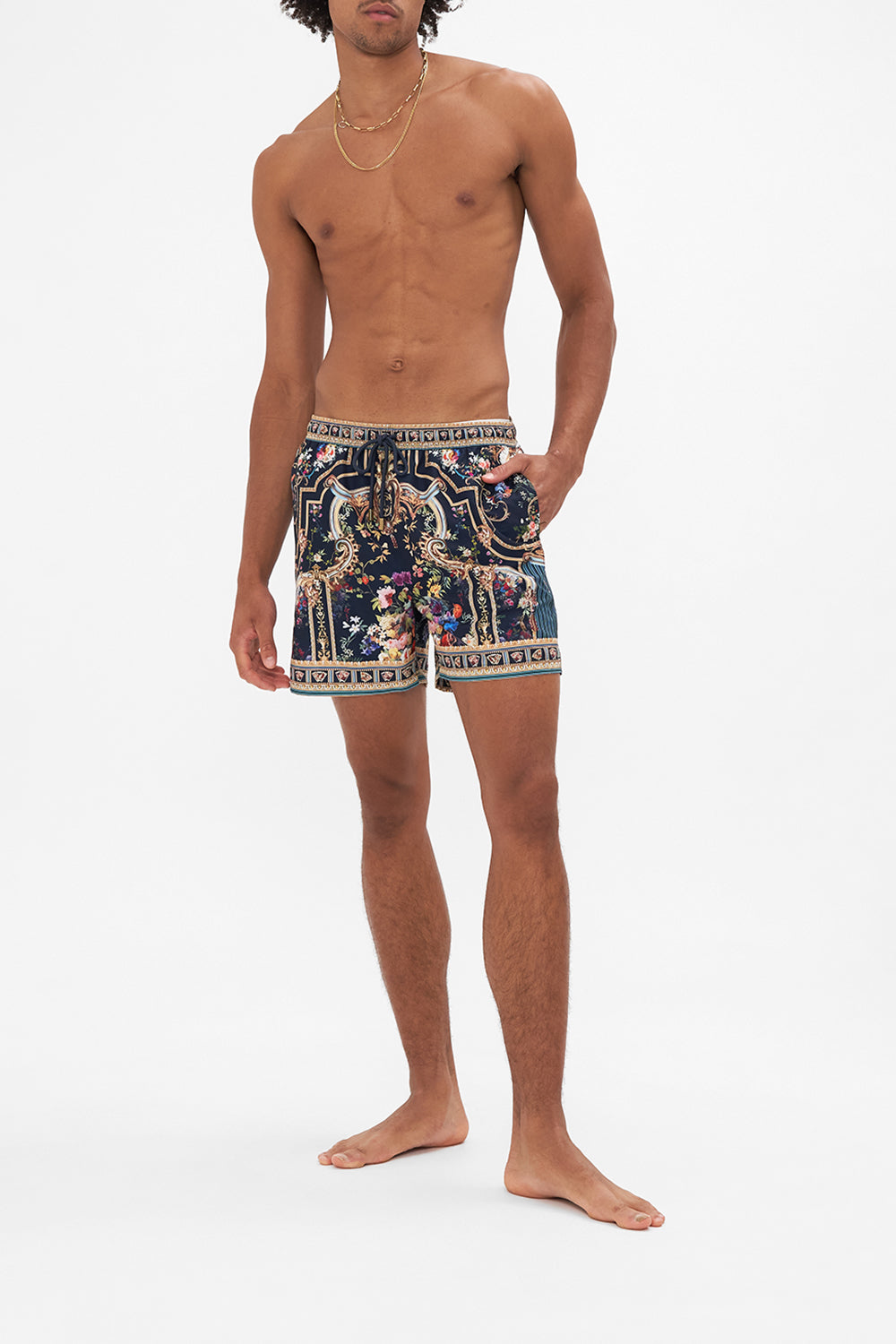 Front view of model wearing HOTEL FRANKS BY CAMILLAmens floral boardshort in Play Your Cards Right print