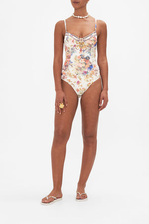 Front view of model wearing CAMILLA floral one piece swimsuit in Friends With Frescos print
