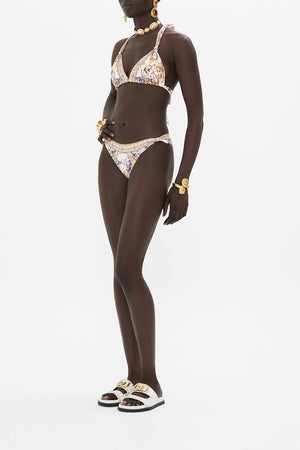 Side view of model wearing CAMILLA designer bikini in Sail Away With Me print