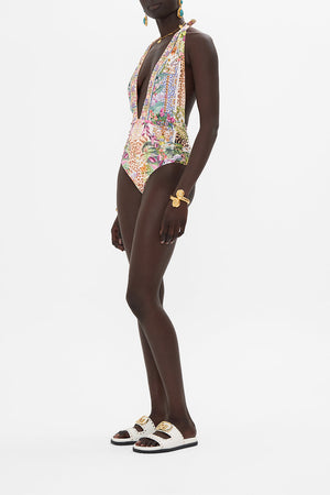 Side view of model wearing CAMILLA resortwear floral onepiece swimsuit in Flowers Of Neptune print 
