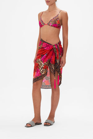 Side view of model wearing CAMILLA resortwear short sarong in Heart Like Wildflower print