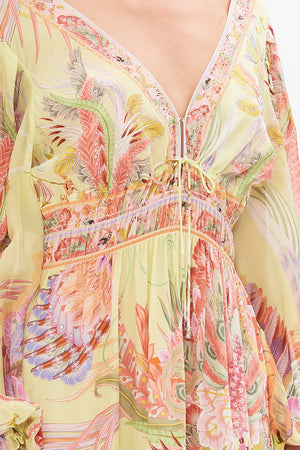 Detail view of model wearing CAMILLA long sleeve silk dress in Cosmic Tuscan print