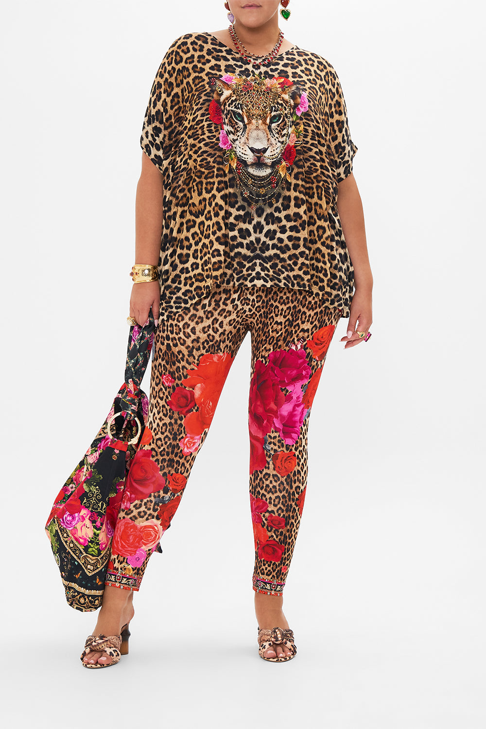 Front view of curvy model wearing CAMILLA  plus size floral leggings in Heart Like A Wildflower print
