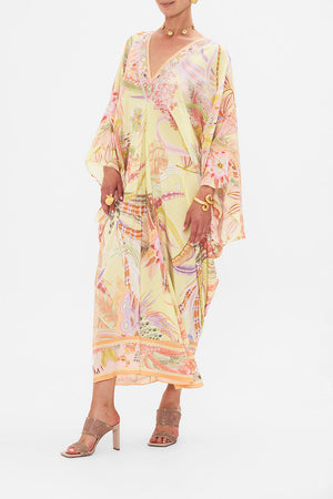 Side view of model wearing CAMILLA designer silk floral kaftan in Cosmic Tuscan print