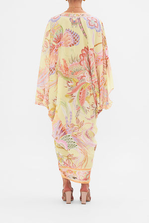 Back view of model wearing CAMILLA designer silk floral kaftan in Cosmic Tuscan print