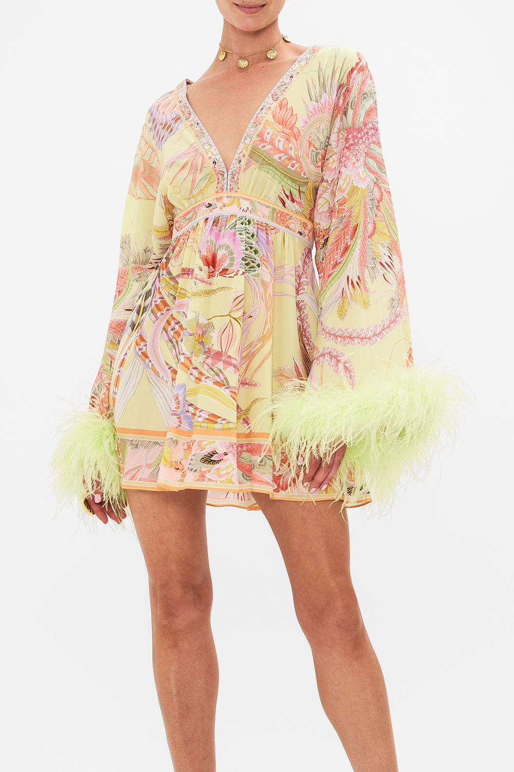 Crop view of model wearing CAMILLA silk kimono mini dress with feathers in Cosmic Tuscan print