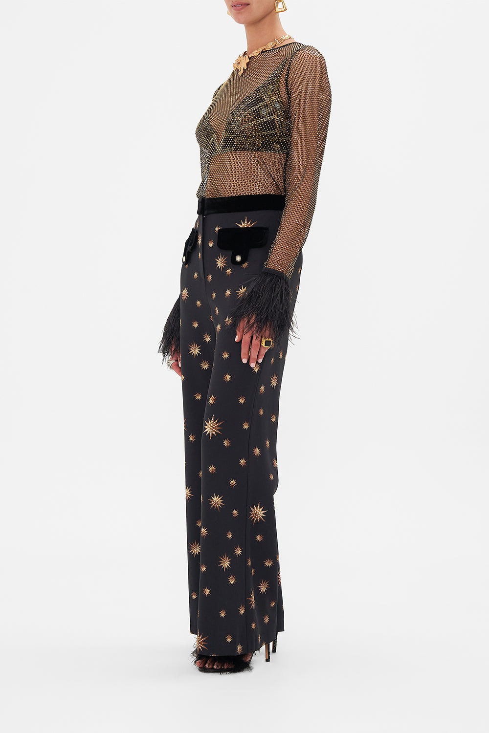 Side view of model wearing CAMILLA designer flared pants in Soul of A Stargazer print