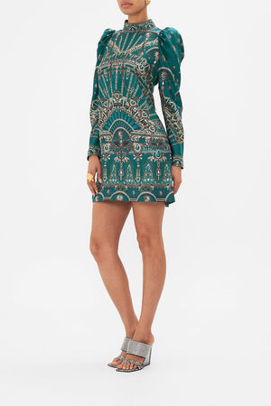 Side view of model wearing CAMILLA puff sleeve high neck mini green dress in A Venice Veil print