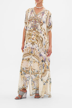Side view of model wearing CAMILLA resortwear silk kaftan in Palazzo playdate print 
