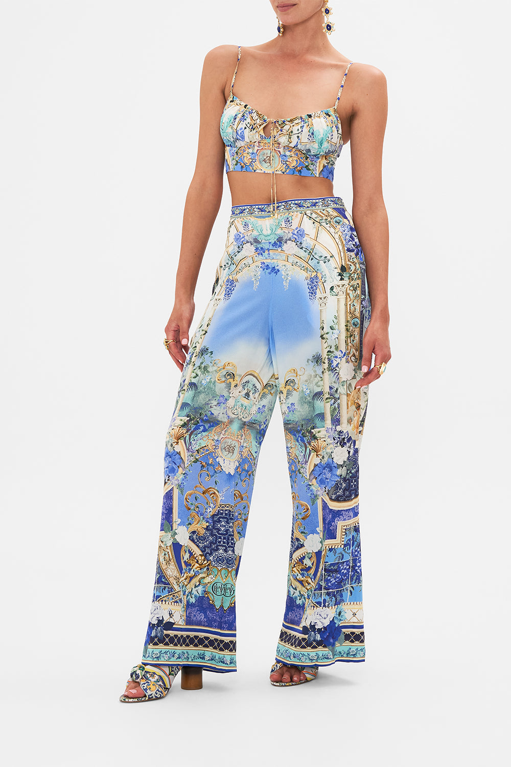 Side view of model wearing CAMILLA silk pants in Views Of Vesuvius print