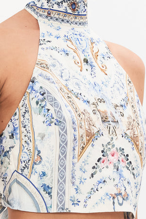 Detail view of model wearing CAMILLA designer halter top in Season of The Siren print 