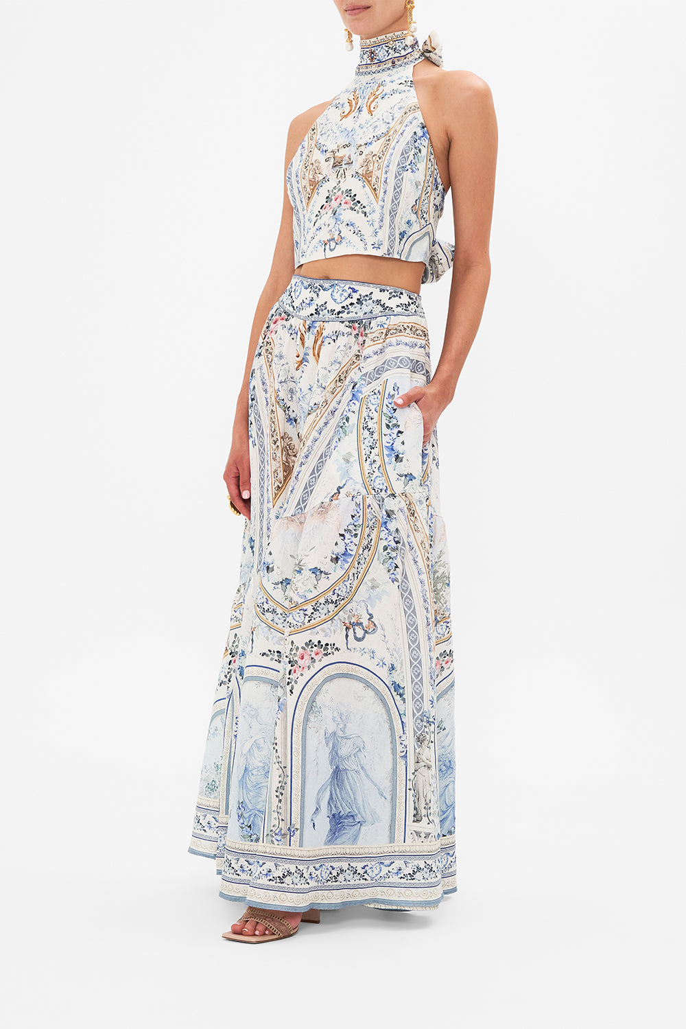 Side view of model wearing CAMILLA designer skirt in Season Of The Siren print 