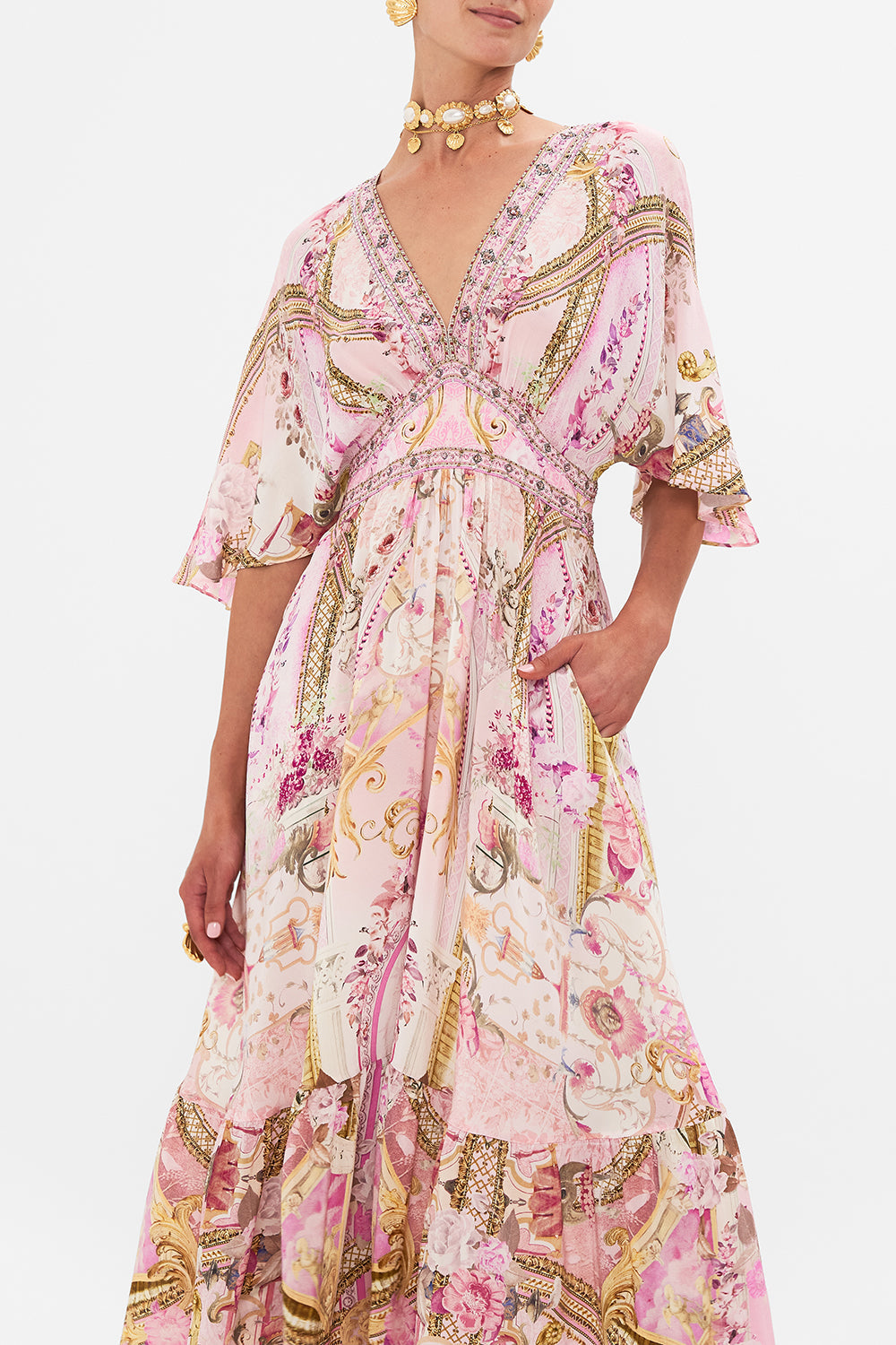 Side view of model wearing pink silk ruffle dress in Fresco Fairytale print