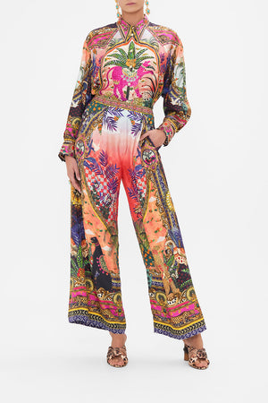 Front view of model wearing CAMILLA silk printed pants in Alessandro's Atlantis print