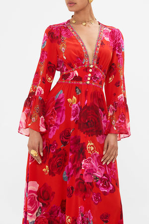Crop view of model wearing designer floral ruffle dress in An Italian Rosa print 