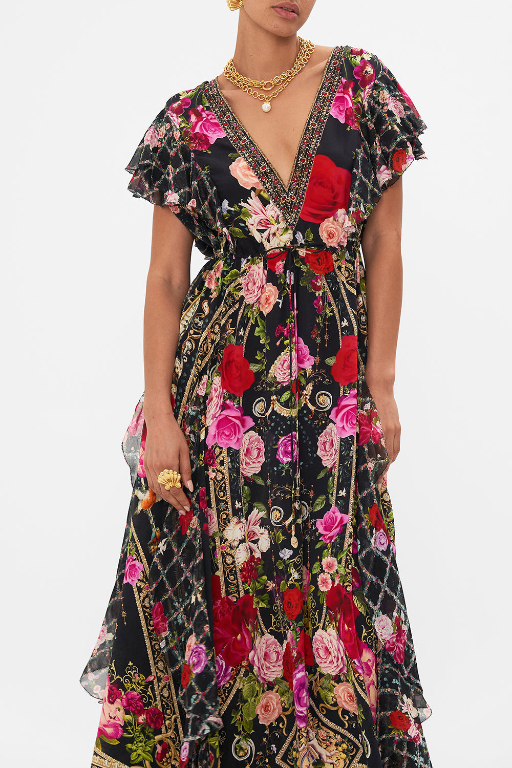 Crop view of model wearing CAMILLA designer floral ruffle dress in Reservation For Love print