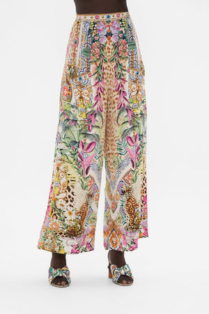 Crop view of model wearing CAMILLA floral silk pants in Flowers Of Neptune print 