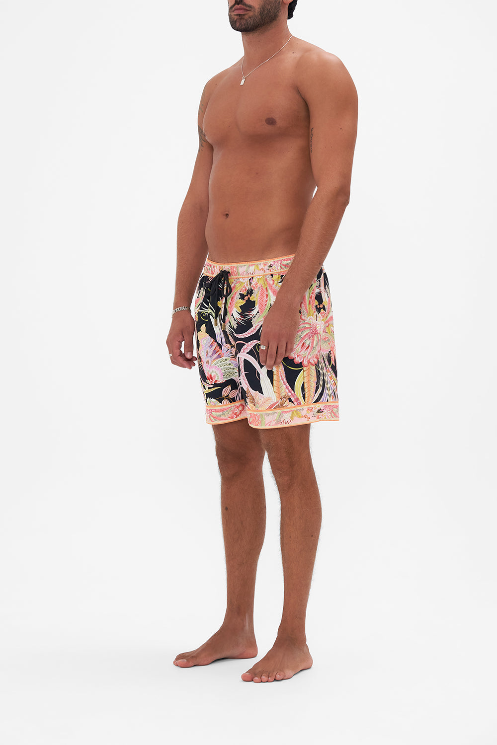 Side view of model wearing Hotel franks by CAMILLA mens boardshorts in Lady of The Moon print
