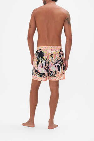 Back view of model wearing Hotel franks by CAMILLA mens boardshorts in Lady of The Moon print