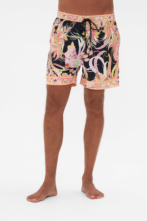 Crop view of model wearing Hotel franks by CAMILLA mens boardshorts in Lady of The Moon print