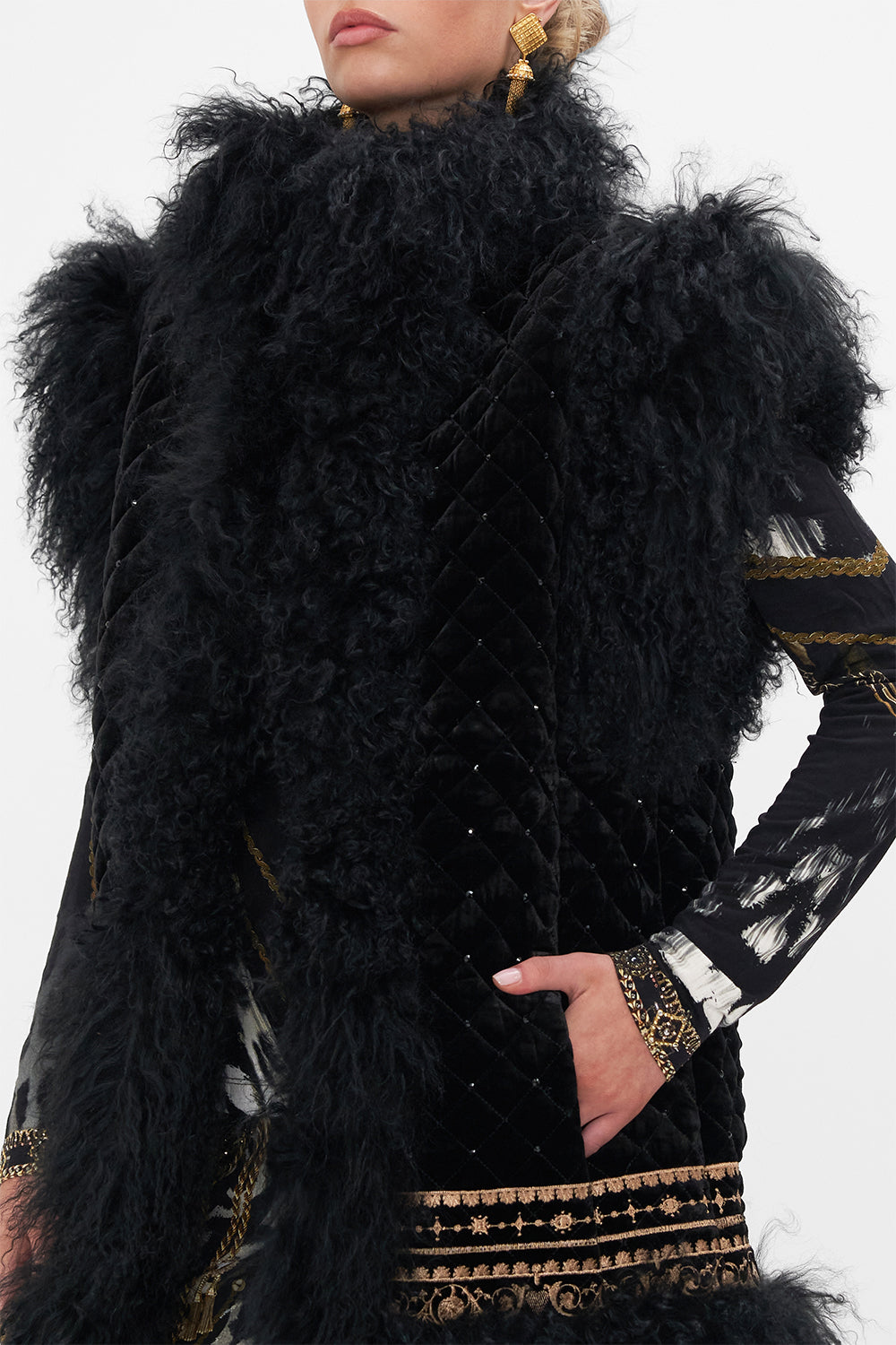Detail view of model wearing CAMILLA black fur vest in Untamed Royalty print