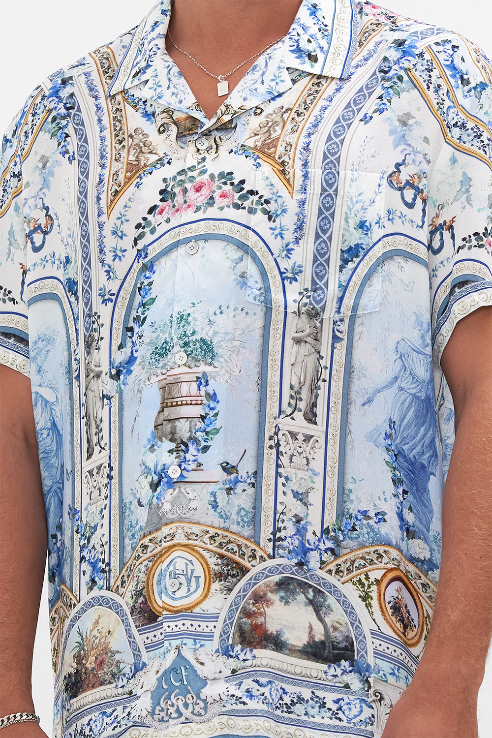 Detail view of model wearing HOTEL FRANKS BY CAMILLA collared shirt in Season of the Siren print