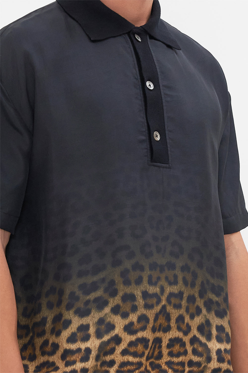 Detail view of model wearing Hotel Franks By CAMILLA mens polo shirt in Masked At Moonlight print