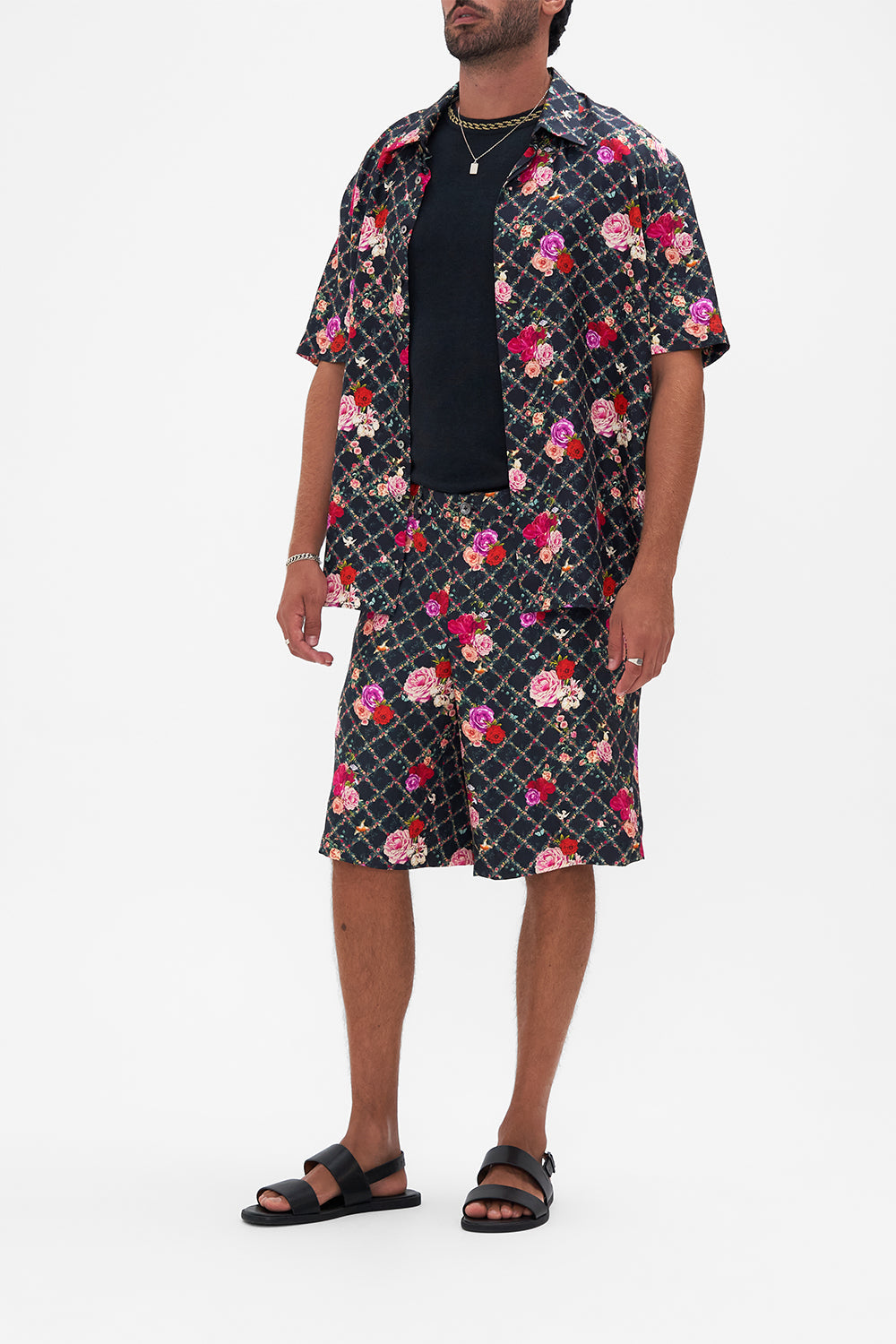 Side view of model wearing Hotel Franks By CAMILLA mens walkshort in Reservation For Love print 