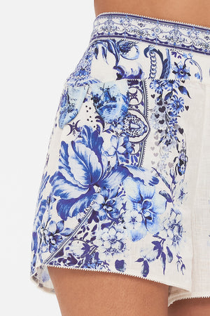 Detail view of model wearing CAMILLA deisgner shorts in Glaze and Graze print