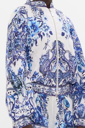 Detail view of model wearing CAMILLA silk bomber jacket in Glaze and Graze print