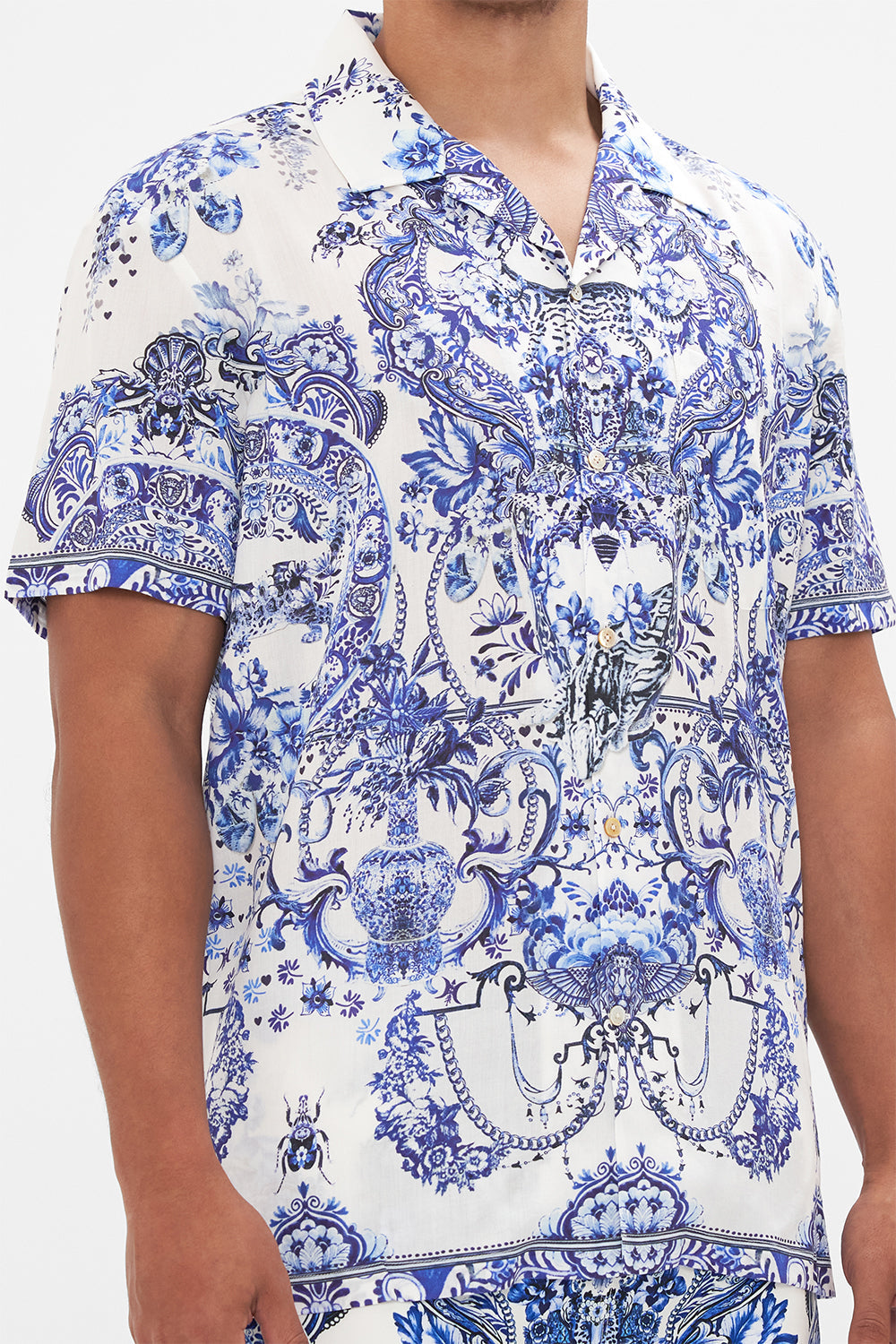 Detail view of model wearing Hotel Franks By CAMILLA mens blue and white shirt in Glaze and Graze print