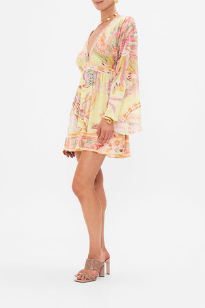 Side view of model wearing CAMILLA silk kimono mini dress in Cosmic Tuscan print 